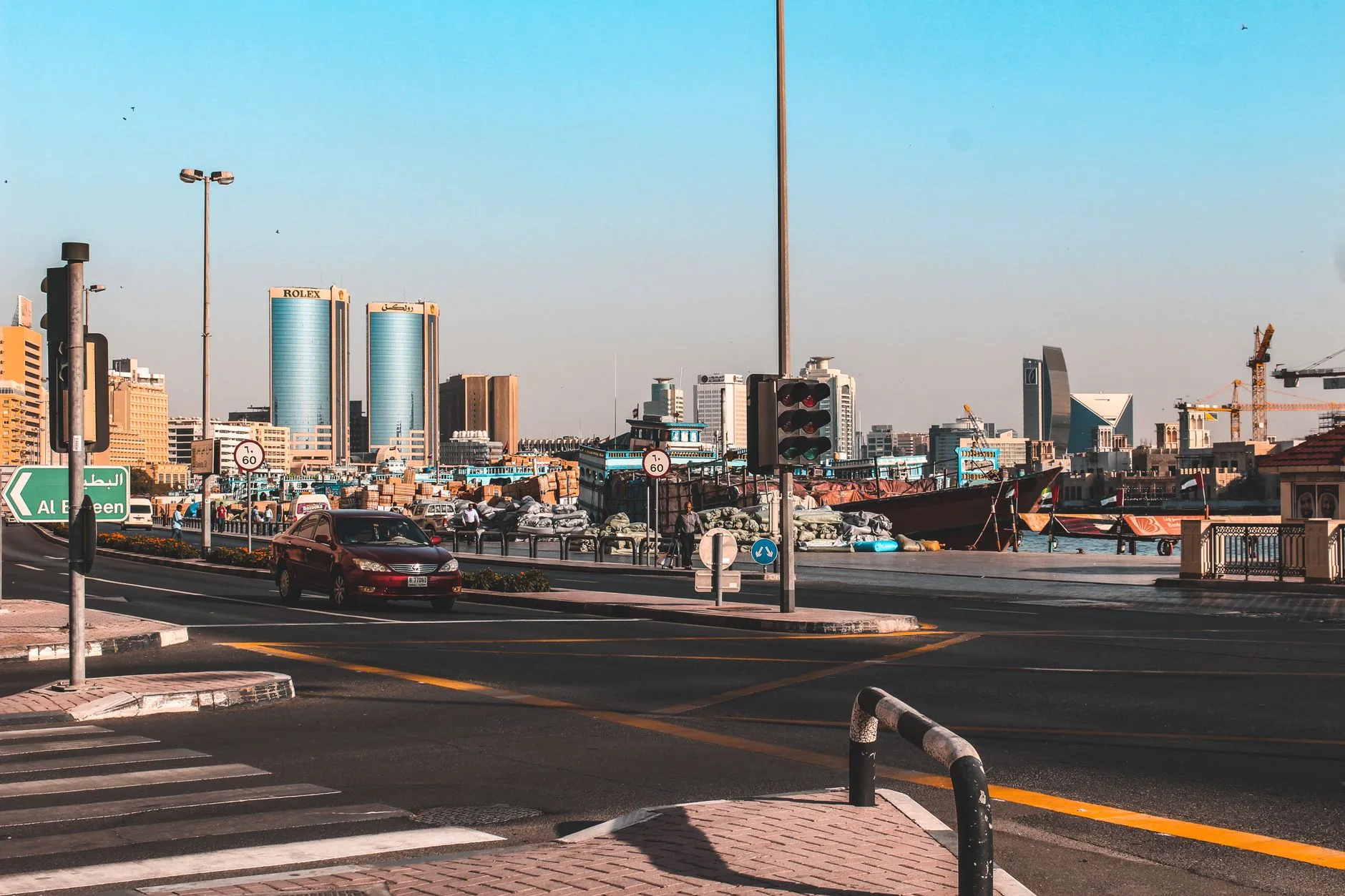 A vibrant street view in Dubai featuring traffic and city skyline with clear skies. — illustrative stock photo